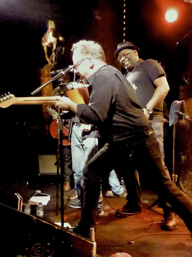 Eric plays slide with the Mic Stand as Claude Zeline looks on.